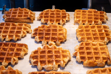 Baked belgian sugar waffles with various toppings, delicious sweet street food in Bruges, Flanders, Belgium