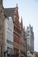 Medieval houses facades and rooftops and city tower with bells in the centre of Bruges, Flanders