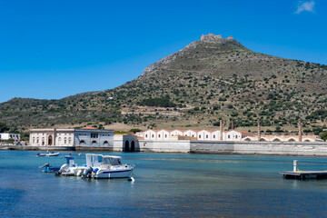 Little traditional colourful fishing boats in Favignana island's harbour, near Sicily, tourists...