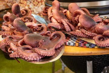 Catch of the day, fresh tasty seafood, grilled octopus sicilian style on fish marken in Palermo, Sicily, Italy, streed food on market