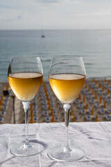 Celebration, birthday party, pouring of sweet muscat white wine from Pantelleria island on holiday on Mondello beach, Palermo, Sicily, Italy