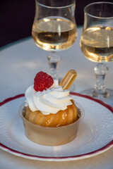 French cuisine, fresh baked baba au rum cake with chantilly cream, sweet dessert with rum and...