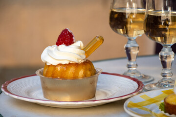 French cuisine, fresh baked baba au rum cake with chantilly cream, sweet dessert with rum and...