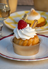 French cuisine, fresh baked baba au rum cake with chantilly cream, sweet dessert with rum and...