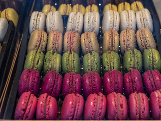 Macarons or French macaroon sweet meringue-based confection made with egg white, icing sugar, granulated sugar, almond meal, and food colouring, sweet french dessert on display