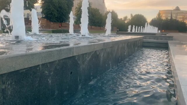 Water Fountains Gushing in City Park at Sunset