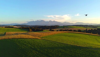 Fototapeta premium Drone flies over fields and mountains