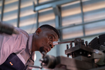 Engineer closely inspecting precision components on a metal lathe machine. Focus, technical...