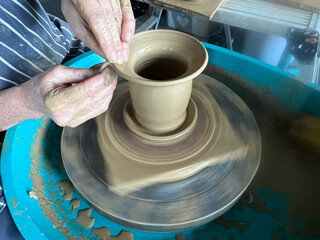 Creating clay on a pottery wheel 01