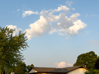 house on the hill with clouds