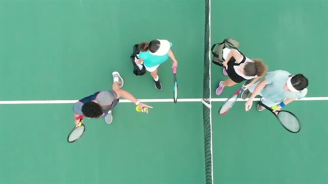 Match ending diverse tennis players walking to net swapping ball can and water bottle returning