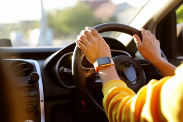Woman behind steering wheel of modern car, closeup