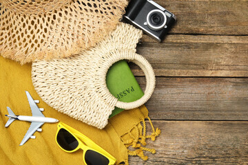 Time for summer vacation. Straw bag with passport, camera, toy plane, sunglasses and beach...
