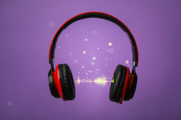 Headphones and sound waves against purple background
