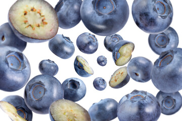 Fresh blueberries swirling in air against white background