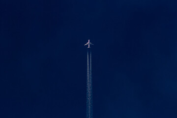 Airplane in the blue night sky. Airplane on the blue sky.
