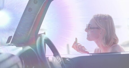 Passenger woman grabbing lipstick and applying lip color under sunlight flares for beauty tutorial