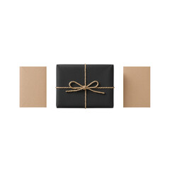 Elegant black gift box with twine bow and kraft envelopes on dark background studio shot