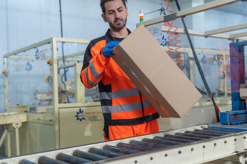 Workers in safety gear inside a factory check equipment and products on production and...