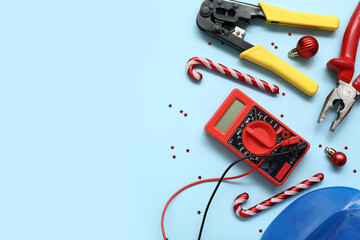 Composition with electrician's tools and Christmas decor on color background