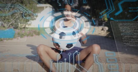 Child boy on brick ledge activating sports tech holographic scan, rotating soccer ball for analysis - Powered by Adobe
