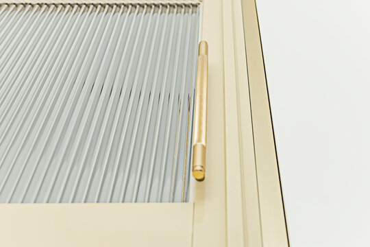 Bauhaus-inspired simplicity: elongated chrome handle providing perfect visual counterpoint to white matte door