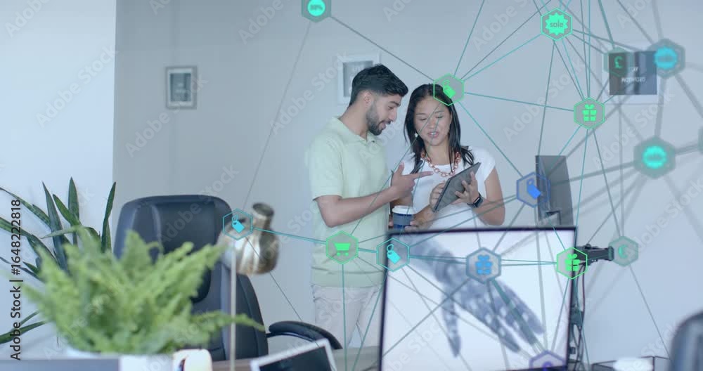 Poster man approaching with coffee and scrolling smartphone as colleague explaining tablet data in office