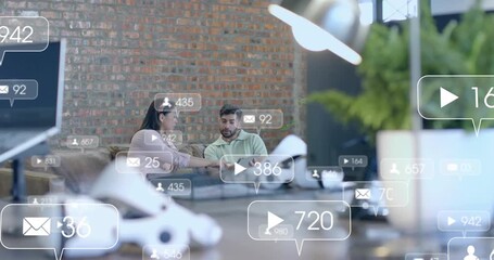 Colleagues tapping tablet and tracking rising social media engagement with floating metric icons - Powered by Adobe