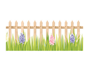 Wooden fence with spring flowers and lush grass