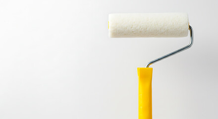 Obraz premium Fresh White Paint Roller with Yellow Handle for Home Improvement and Renovation