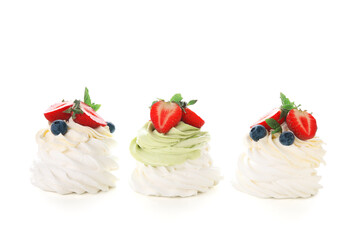 Sweet Pavlova cakes with fresh berries and mint on white background