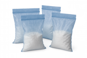 Transparent plastic zipper bags filled with white powdery substance, arranged against clear background