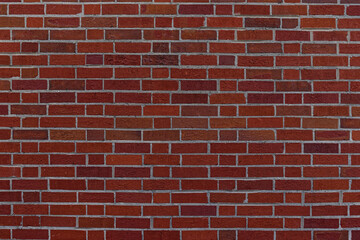 Dark red brick wall texture with mortar lines
