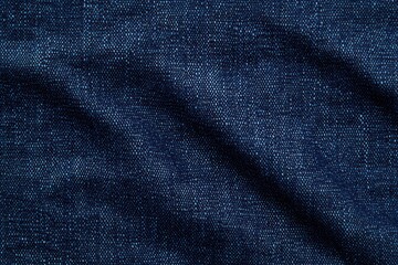 Naklejka premium Close-up of dark blue denim fabric with visible thread texture and subtle creases