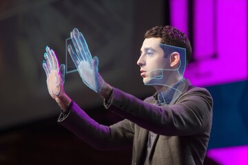 Man experiencing augmented reality, gesturing towards a holographic display with glowing lines.