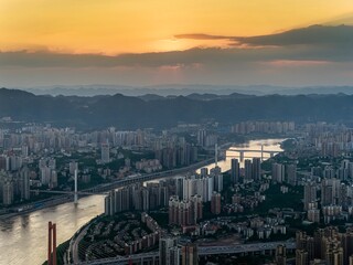 Chongqing showcases stunning summer vibes with vibrant city lights during an evening urban...
