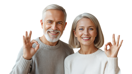 Joyful Elderly Couple Making OK Gestures Together