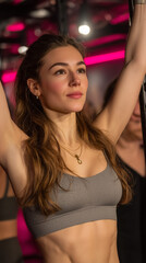 Woman in sports bra exercising in gym with pink neon lights