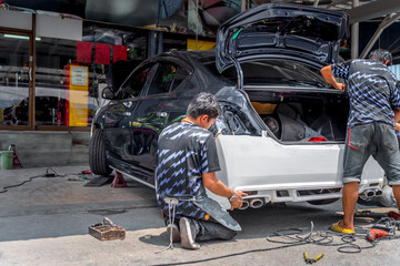 Checking car body work fiber bumper at car garage