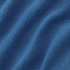 Fototapeta premium Close-up of blue denim fabric with visible weave texture and subtle shadows creating a slightly folded appearance