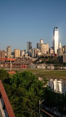 Obraz premium Chongqing skyline features urban vibrancy and stunning river views under a clear blue sky in the evening light