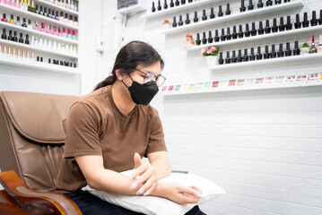 Woman (LGBTQ) do a manicure or pedicure at nails