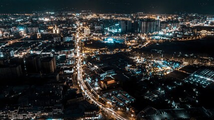 Obraz premium Enchanting night view of Xichang, China showcasing illuminated skyline and vibrant urban life