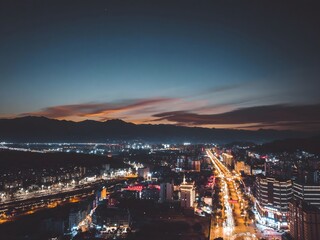 Fototapeta premium Enchanting night view of Xichang, China showcasing a vibrant urban landscape and glowing city lights over the horizon