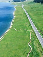 Stunning aerial view of Sayram Lake in Xichang, China showcasing turquoise waters and serene mountain landscapes