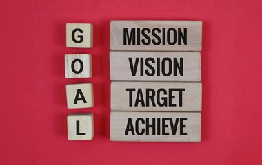 Wooden blocks with the words 'goal, mission, vision, target, achieve' written on them. Isolated on...