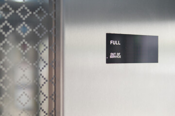 Elevator display showing full and out of service status