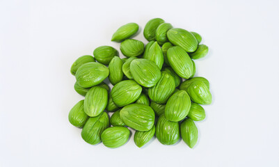 A pile of fresh petai or pete, also known as stinky beans, isolated on a clean white background.