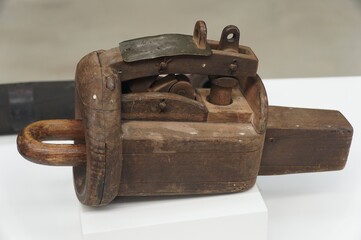 An antique and vintage wooden pulley, also known as a block and tackle, used to lift heavy objects.
