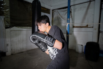 Young Boxer Practicing Guard Position in Indoor Gym